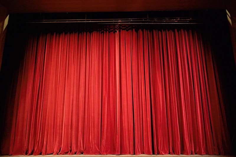 Image of closed stage curtains.